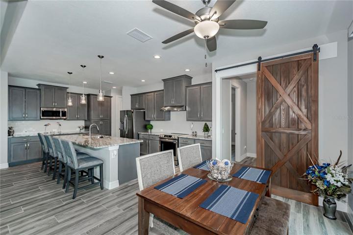 adjacent dining with decorator barn door