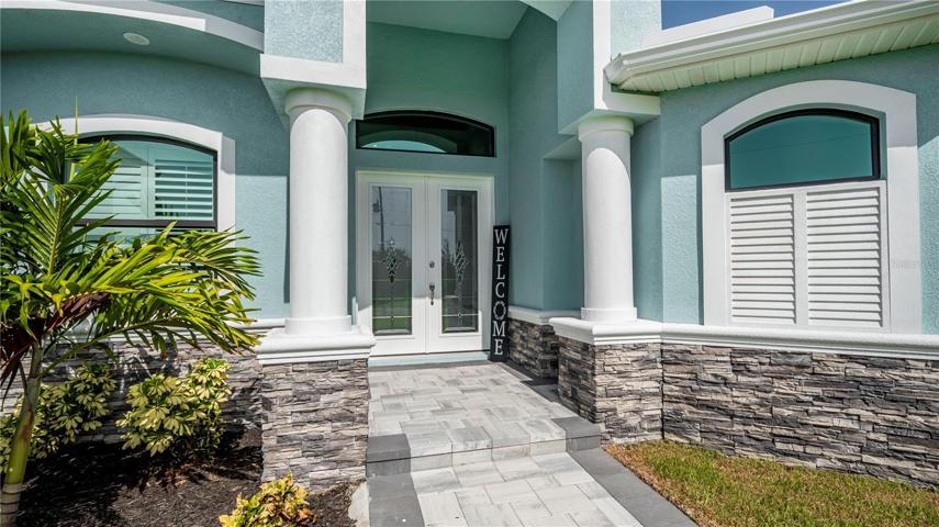 soaring covered entry with spectacular columns