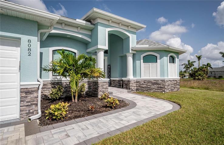 rich stone work and paver lined drive/walkways