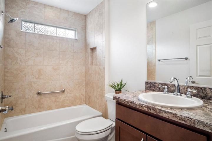 GUEST BEDROOM WITH TILE AND GRAB BARS