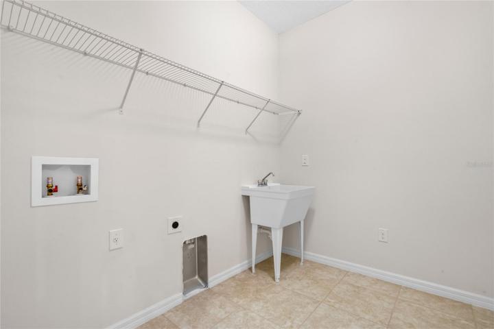 Laundry space for oversized washer and dryer, laundry baskets, plus laundry sink.