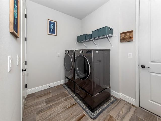The laundry room is spacious offers plenty of room for additional storage.