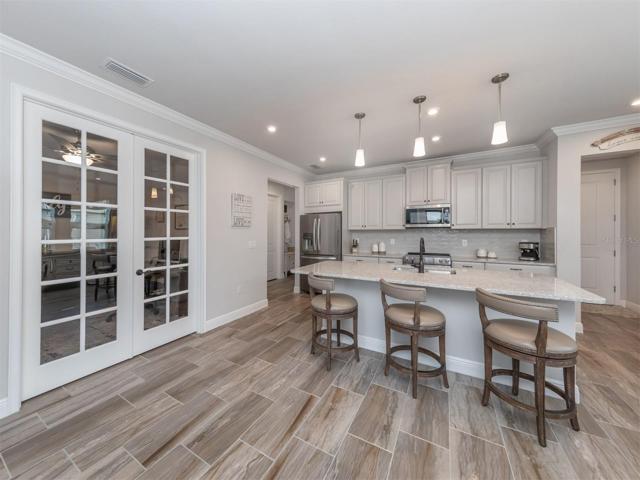 The den is located just off the kitchen and makes the perfect office or craft room