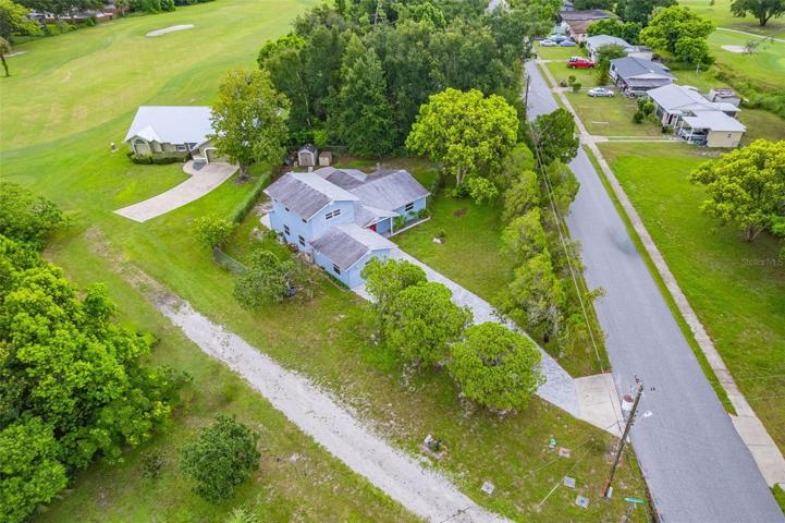 Aerial view of property with golf course in the near distance