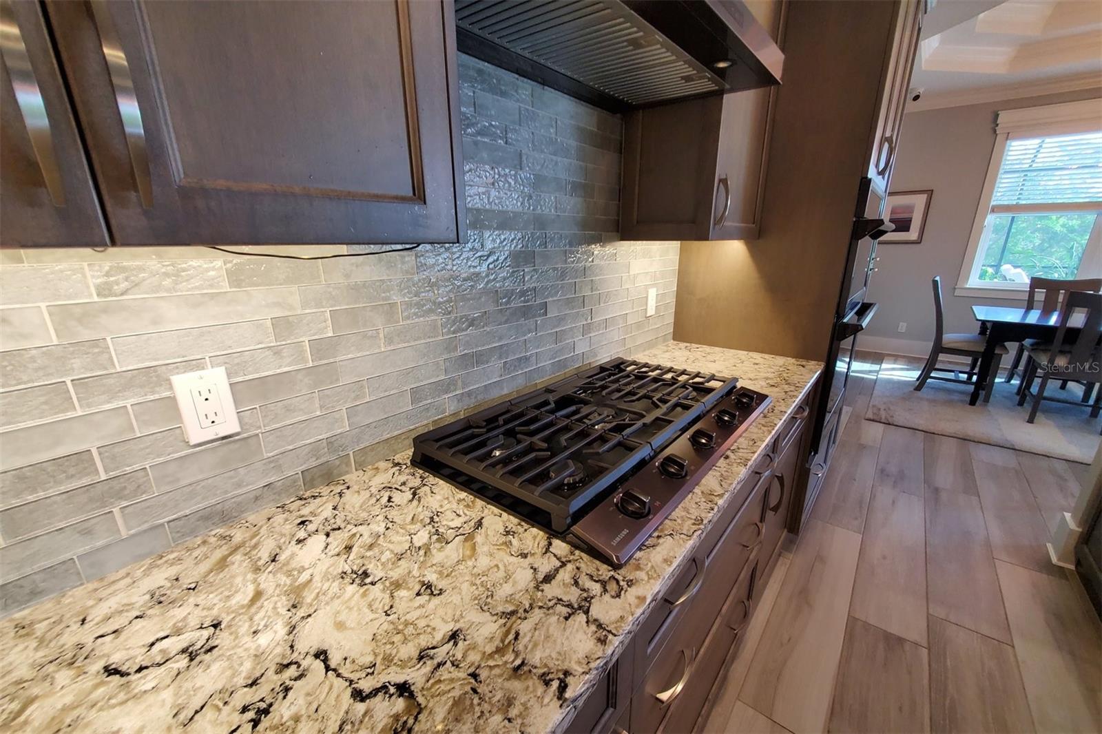Extended gas cooktop with storage underneath.