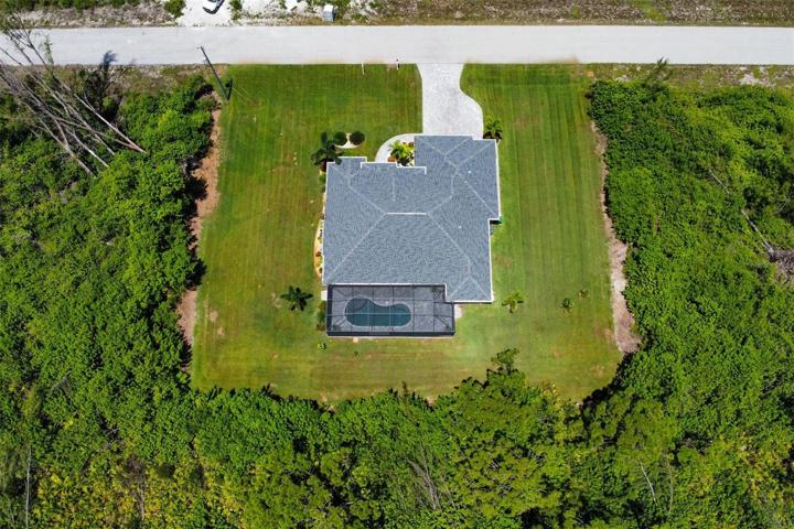Large spacious yard with wooded preserve behind.