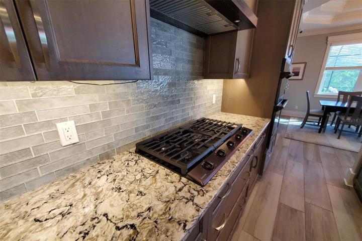 Extended gas cooktop with storage underneath.