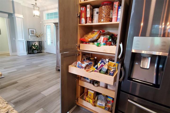 Custom slide out shelves in the pantry.