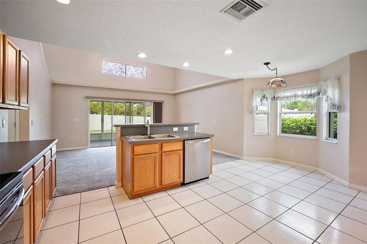 Kitchen has Island with Snack Bar and Eat-in Dining with Bay Window.