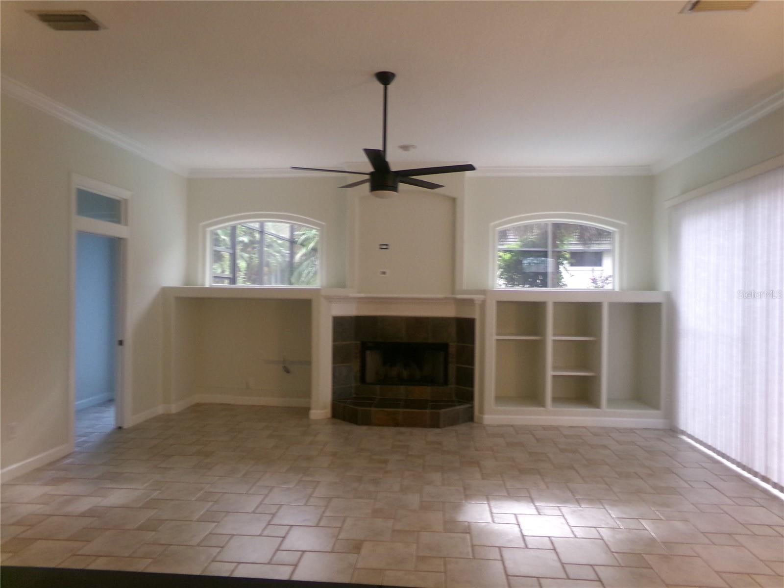 FAMILY ROOM WITH FIREPLACE TILE FLOOR