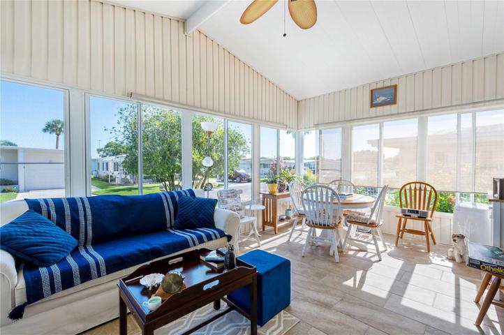 Many windows, tile flooring and ceiling fan in this enjoyable space.