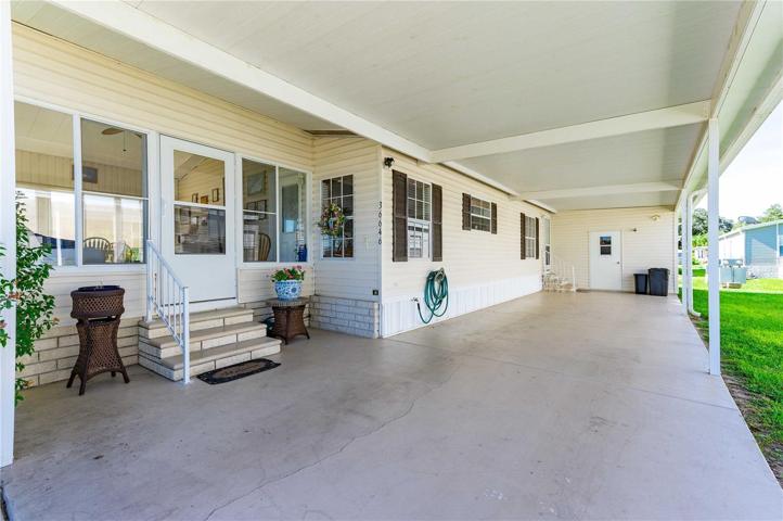From carport entering into front Florida room.