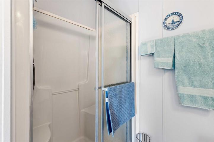 Step-in shower in this master with bench.