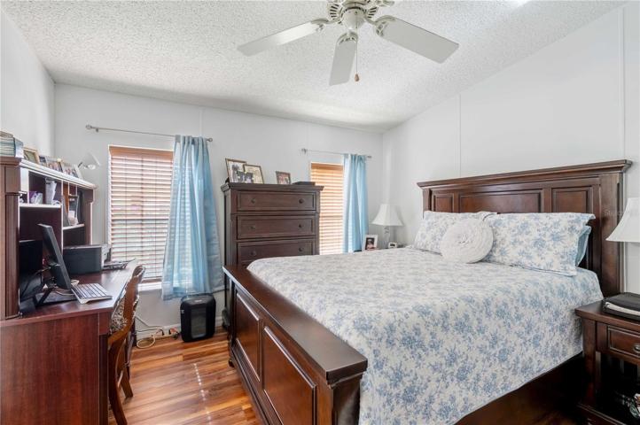 Master bedroom has updated flooring, ceiling fan, closet organizer, new blinds, and fresh paint.