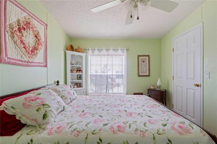 Bedroom #2 has walk-in closet, updated ceiling fan, fresh paint, and updated flooring.