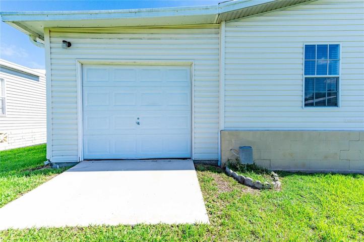 Back of home has a golf cart garage with workshop.