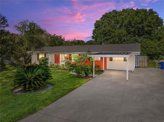 Front of home with double wide driveway.