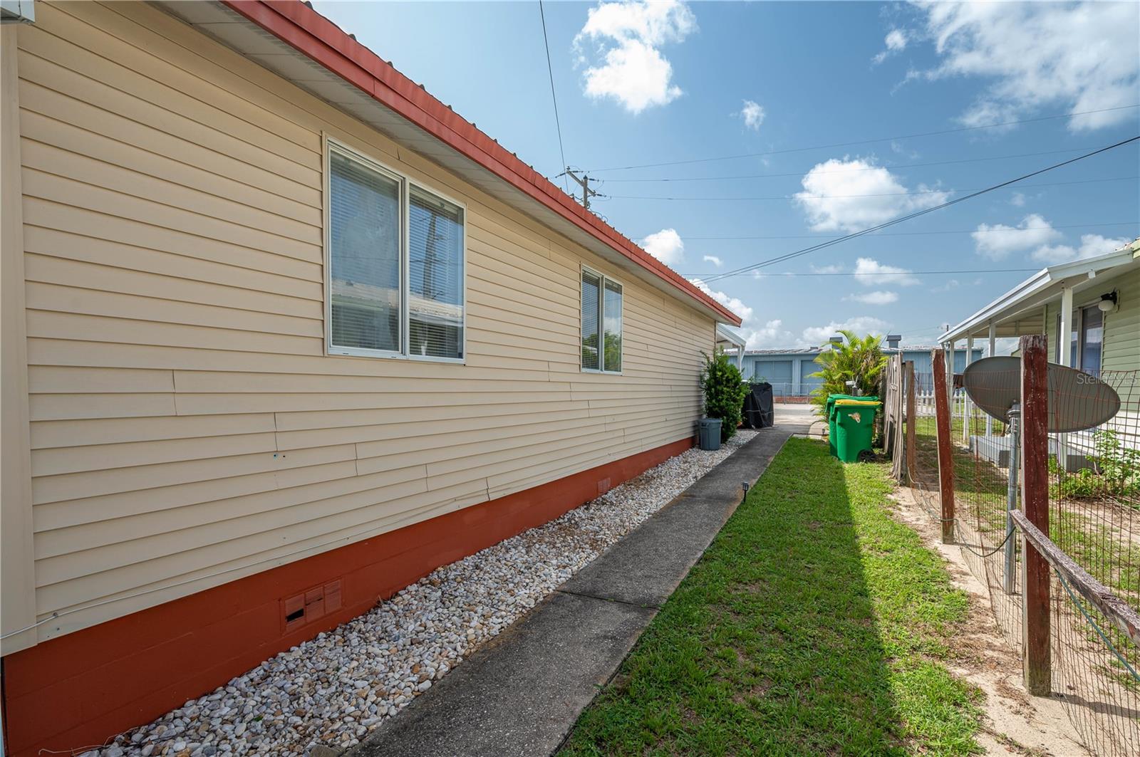 L Side of house facing road. Walkway to #B