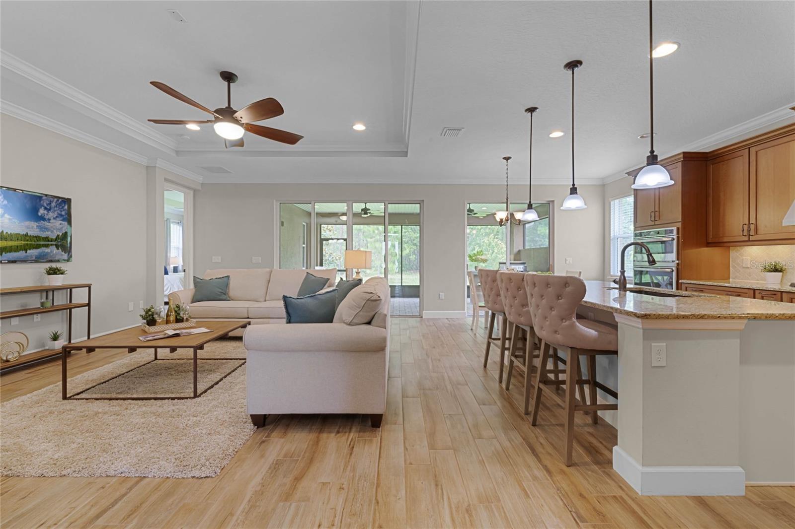 View of Great Room &amp; large breakfast bar w/ pendant lighting above