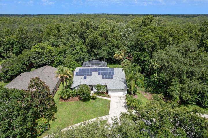 **OVIEDO POOL HOME** Prepare to be captivated by this remarkable home that promises a serene and idyllic living experience on an oversized lot that backs to a wooded view!