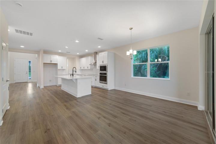 From the moment you step inside, you'll be greeted by a spacious flowing layout that provides ample natural light throughout as well as LUXURY VINYL PLANK FLOORS in the main living areas!