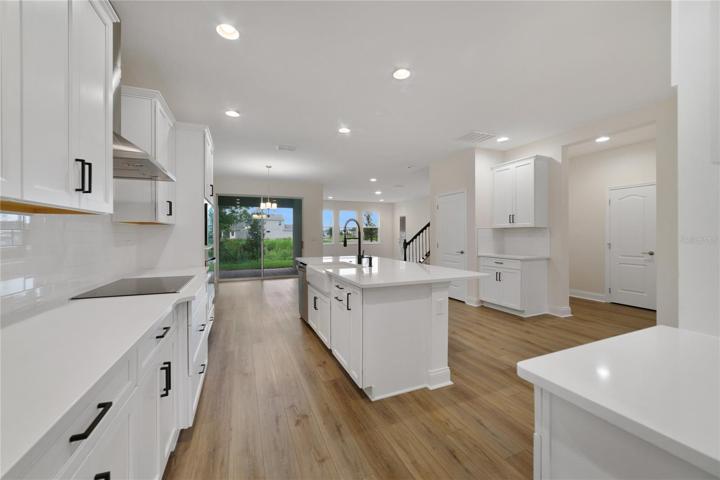 The gorgeous kitchen features HIGH-END APPLIANCES (built-in oven!), beautiful shaker-style cabinetry, WALK-IN PANTRY and a large ISLAND with bar seating, making it the perfect space for culinary enthusiasts and entertainers alike!