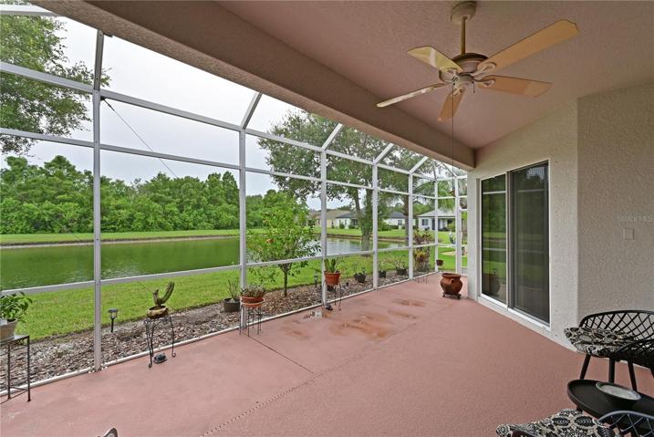 Spacious extended lanai with a lake view