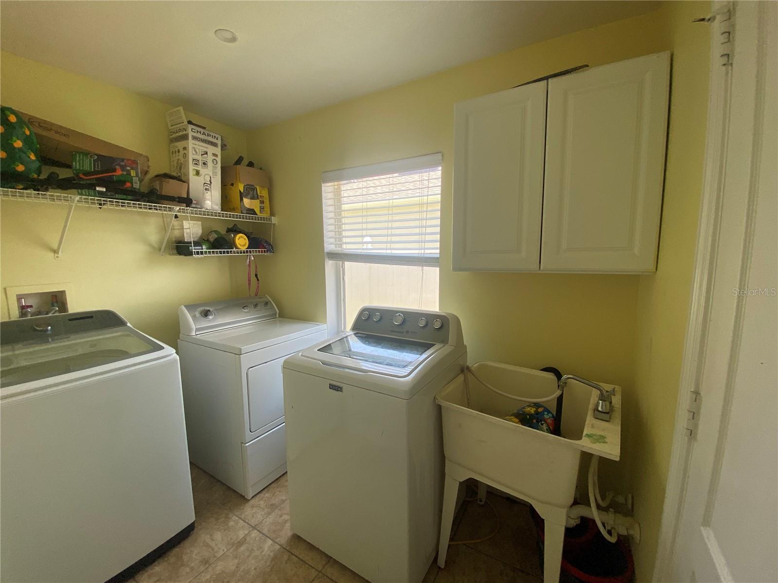 Indoor laundry room with sink.  Door on right leads to garage.