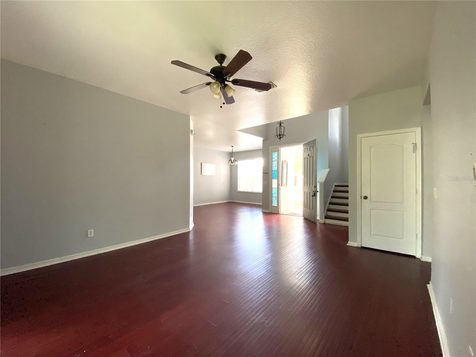 View from living room into dining room. Door is under stairs storage