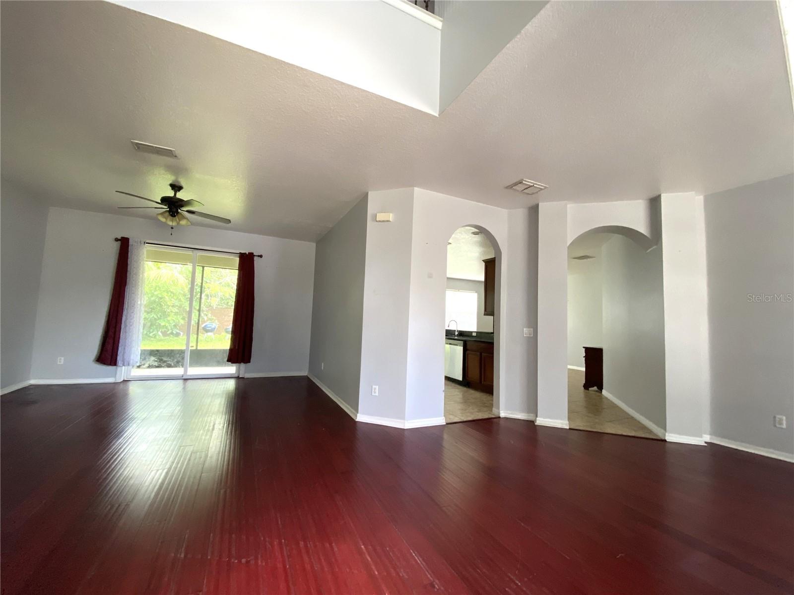 Another view from front door.  Living room on left, dining on right, with arched entrances into kitchen and family room in the middle
