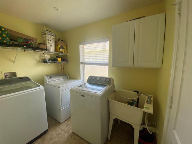 Indoor laundry room with sink.  Door on right leads to garage.