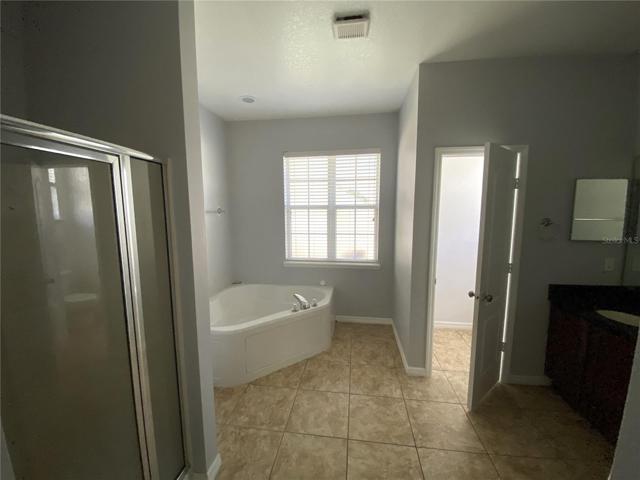 Master bath with shower stall, soaking tub, toilet closet and double vanity with granite tops