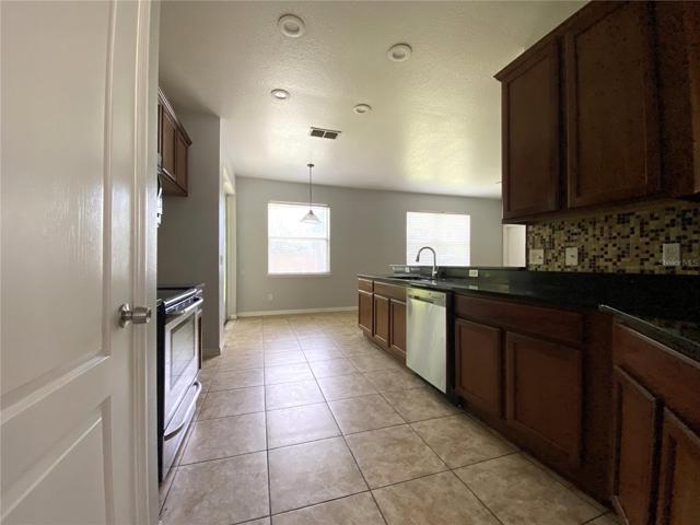Kitchen with 18" ceramic tile, 42" cabinets and granite countertops