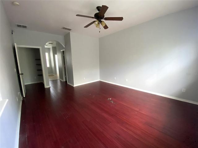 Master with a look into the hallway on left, bath in the middle through arch and closet on right