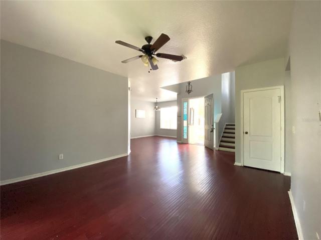 View from living room into dining room. Door is under stairs storage