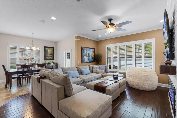 The dining area is perfectly situated in front of sliding glass doors for access to the COVERED LANAI and the living area in an entertainer’s dream with a stunning ELECTRIC FIREPLACE set in a stacked stone surround with built-ins on either side for additional storage!