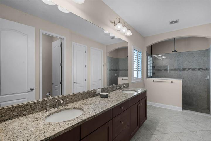 Your en-suite offers an extended dual sink vanity for more great storage, a water closet and an oversized custom tiled walk-in shower with dual (rain!) shower heads!