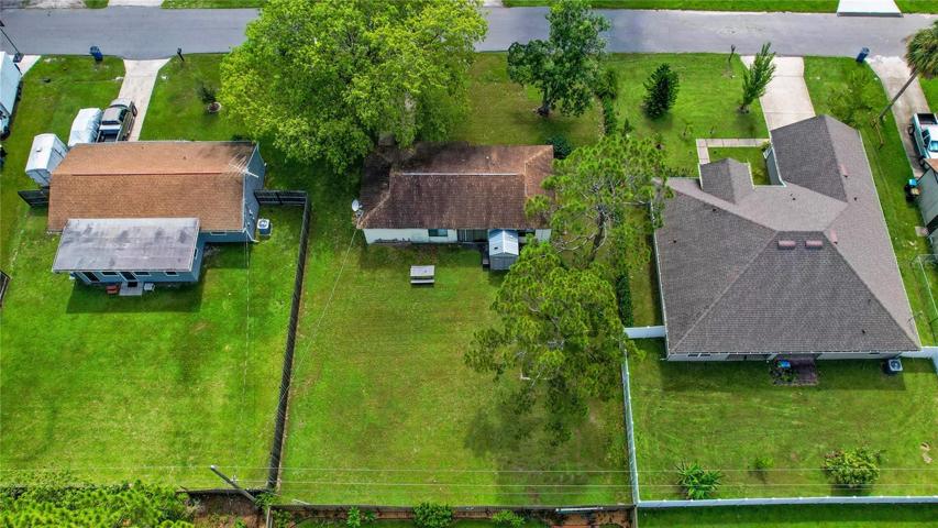 The almost quarter acre lot has lovely mature trees and bordering neighbors create a partial fence!
