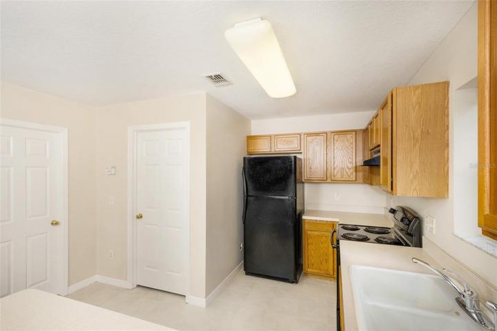 Kitchen view with door leading to bathroom and garage
