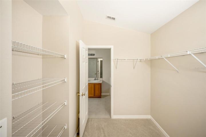 Main closet with door leading to bathroom