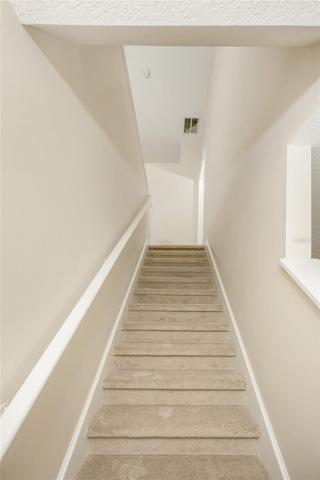 Stairs with NEW carpet leading to second floor