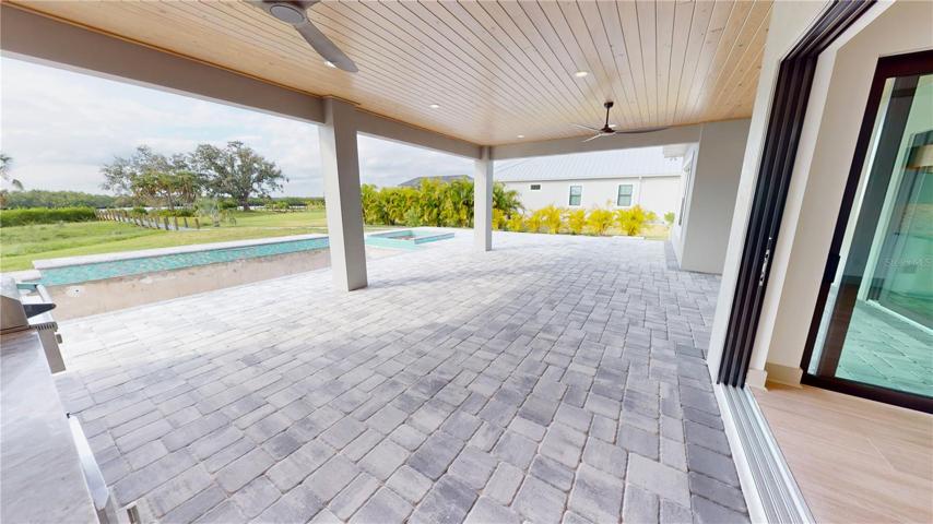 Large under-roof lanai and screened pool enclosure