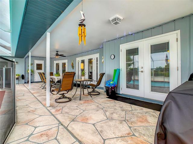 Very Large Covered Lanai for all your family get together's and parties. Door to the far end goes into the guest bathroom. Stamped Concrete Floor is High Quality and not cheap pave stones or cool decking.