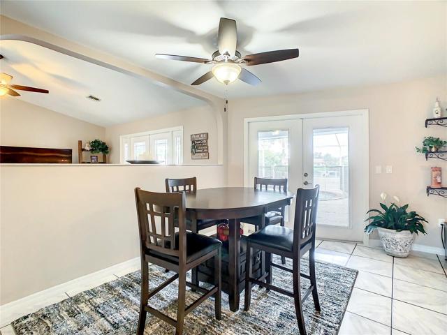 Breakfast Nook/Dinette. Double French Doors to the Lanai/Pool area are Hurricane Impact with Enclosed Shutters
