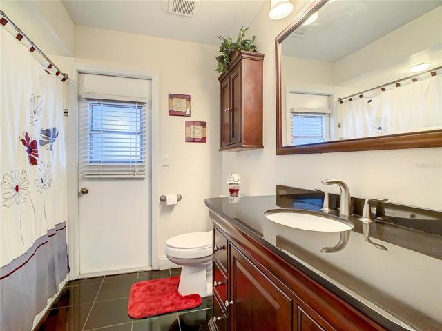 Guest Bath is also updated and features a door to the Pool/lanai and has a tub/shower.