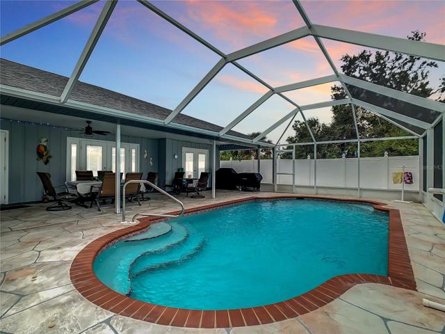 Large Heated Pool approximately 31 ft. long and 14 ft wide. Please note the stamped concrete pool deck, not the usual cheap paver stone or cool deck builders use. Also the covered Lanai cannot be duplicated in similar homes, approximately 37 ft long!