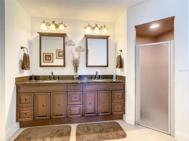 Master Bath Dual Vanity with Granite Counter Tops, Dual Sinks and Mirrors. Tile Lined Walk In Shower