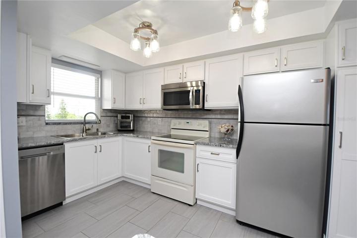 The remodeled kitchen is a chef's dream, featuring stainless steel appliances and stunning granite countertops.