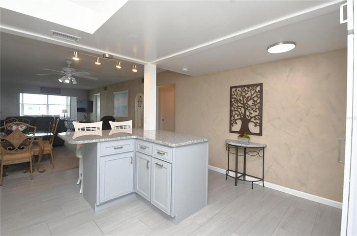 The L-shaped island with a breakfast bar provides the perfect spot for entertaining friends and family.