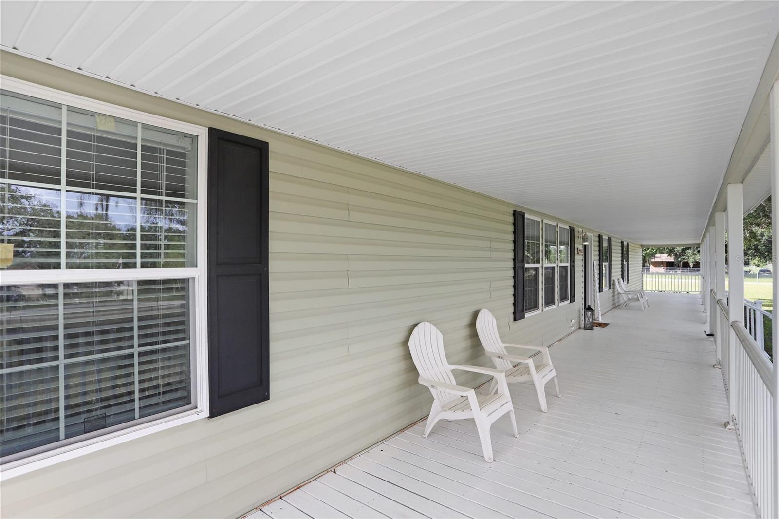 Look at this gorgeous front porch that faces East!  Some couches and/or a table with chairs could be added for relaxation on those mornings where you'd like to sip your coffee and watch the sunrise.